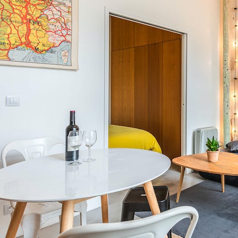 Share an aperitif of French cheese and wine at the dining table