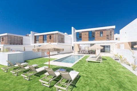 Stretch out on the lawn beside the sun-soaked pool
