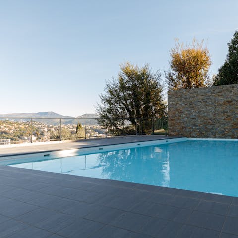 Cool off in the shared swimming pool overlooking the mountains