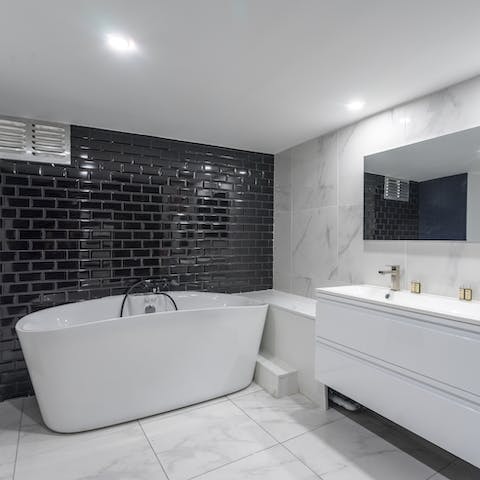 Treat yourself to a long soak in the main bedroom's freestanding Jacuzzi tub