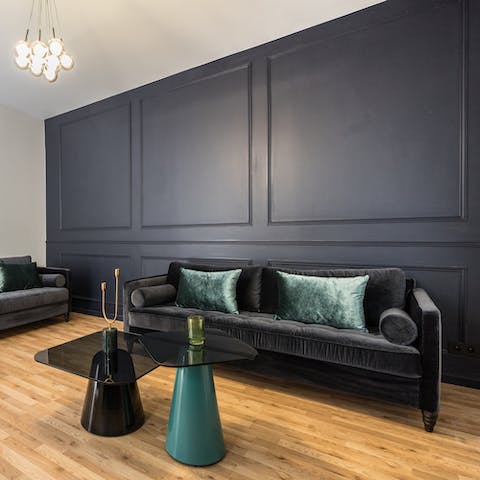 Make yourself comfortable on the swish velvet sofa set with a glass of French wine