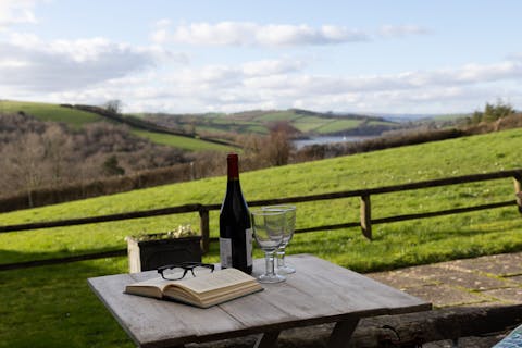 Soak up the views at the outdoor table, a glass of wine in hand