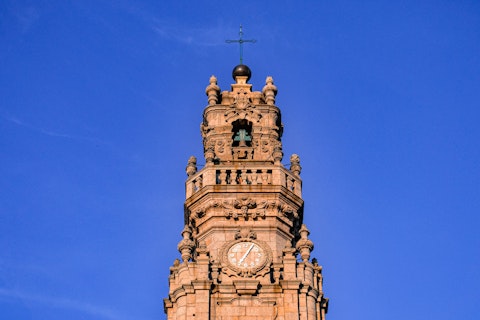 Climb Porto's iconic Clérigos Tower for breathtaking city views, a twenty-minute walk