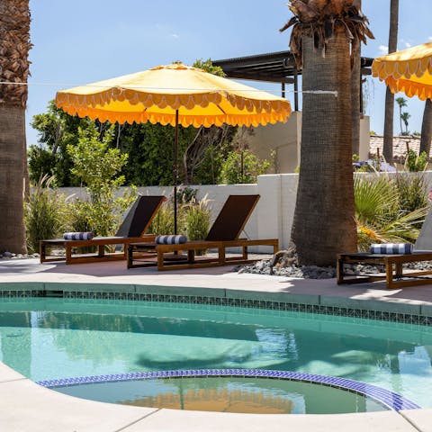 Enjoy a walled backyard oasis with pool and fire pit
