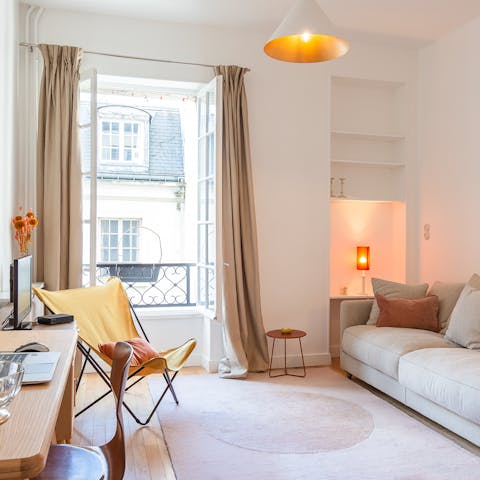 Open up the large windows to admire the quintessential Parisian architecture