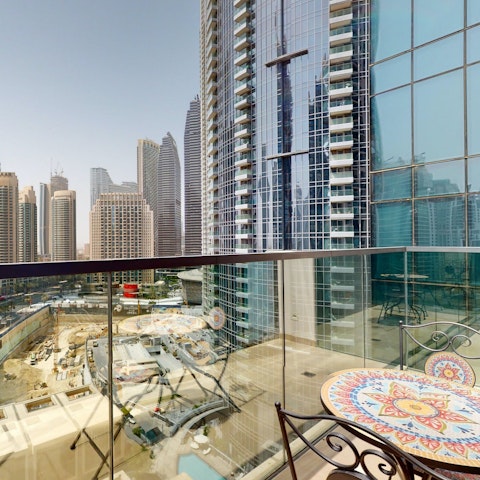 Enjoy a skyscraper view with a cup of coffee on the balcony