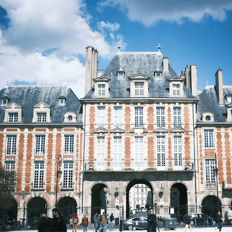 Stroll around Place des Vosges, the oldest planned square in Paris