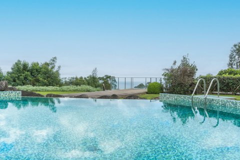 Cool off with a dip in the swimming pool, surrounded by lush gardens
