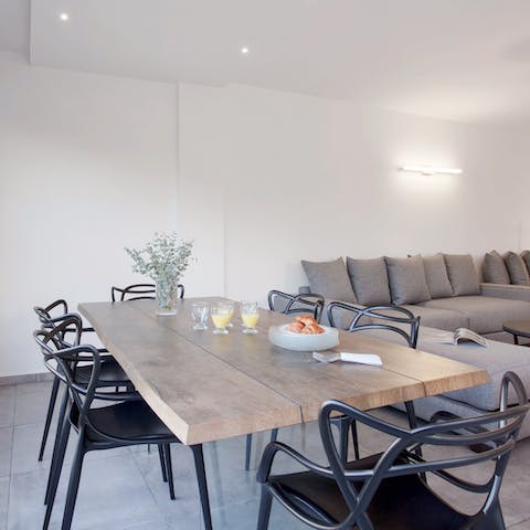 Enjoy a light breakfast of labne and pita at the sleek wooden dining table