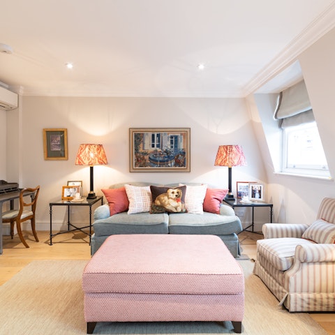 Relax in the bright living area with a glass of wine after a busy day of exploring