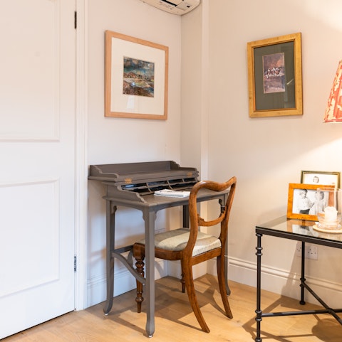 Catch up on work at the living room's bureau