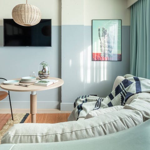 Curl up on the comfy mint-green sofa after a day of exploring the city