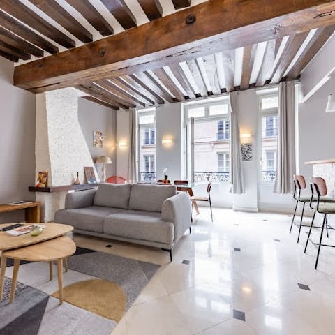 Have a glass of Champagne in the bright living room after a busy day in Paris