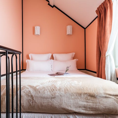 Get a restful night's sleep in the peach-toned mezzanine bedroom