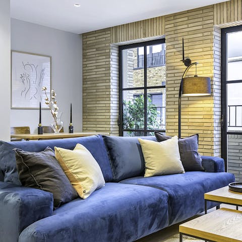 Get comfortable on the blue velvet sofa with a gin and tonic at the end of the day