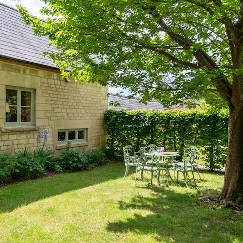 Dine alfresco in the lush garden and enjoy views across the valley
