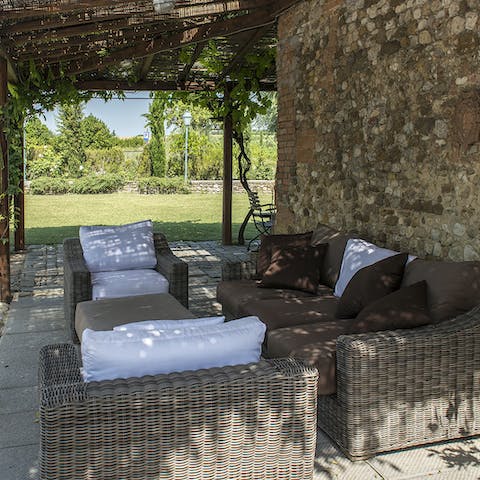 Gather for an aperitif with garden views on the lounge terrace