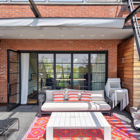 Head up to the rooftop and catch the sun setting over New York's rooftops