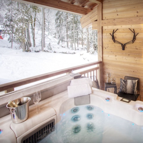 Soak tired muscles in the hot tub as you admire the snowy scenery