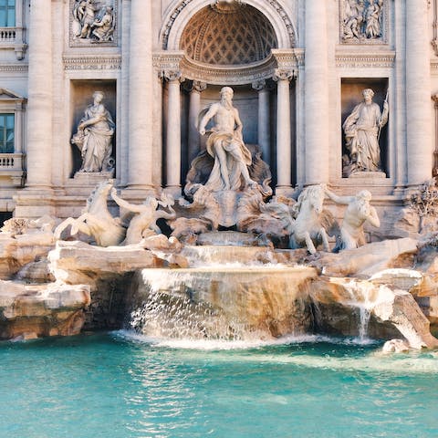 Throw a coin into the Trevi Fountain, located a twenty five minute metro away