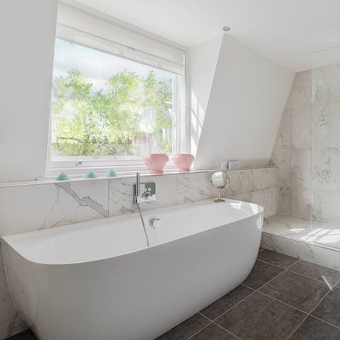 Have a luxurious soak in the bath in the chic bathroom