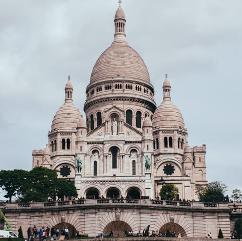 Gaze up at the beautiful Sacré-Cœur Basilica, a ten-minute walk away