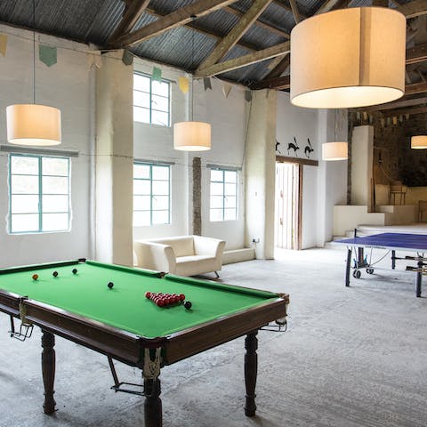 Chill out in the games space, set up in a rustic converted barn