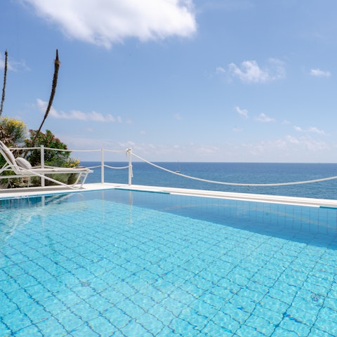 Spend serene days stretched out by the cliffside pool
