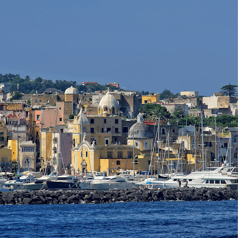Tour the coastline of Ischia by boat or walk to Spiaggia della Chiaia