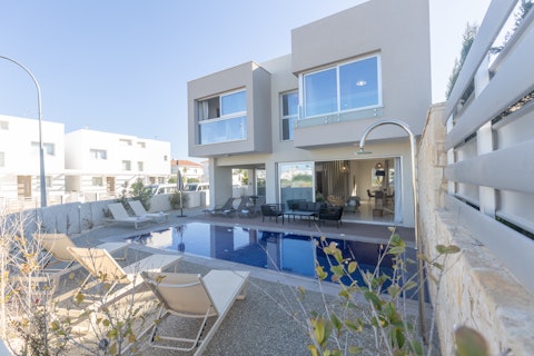 Stretch out on a sunbed beside the glistening pool