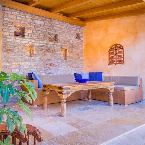 Enjoy drinks and dining alfresco in the covered dining space on the terrace