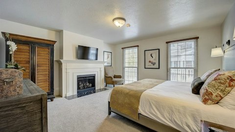 Curl up beside the fireplace from bed after a day on the slopes