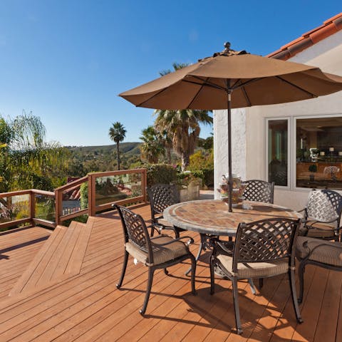 Gather around the outdoor table for drinks at sunset