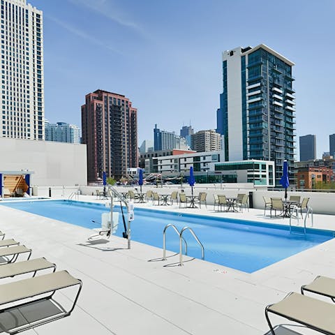 Swim and lounge at the rooftop pool with skyline views