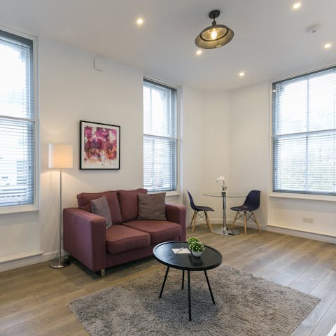 Kick back in the bright living room with a glass of wine or gather for a meal at the cosy corner table