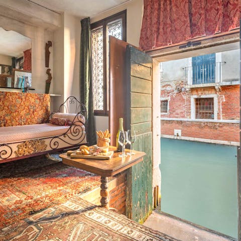 Sit back and look out at the canal as gondolas pass by