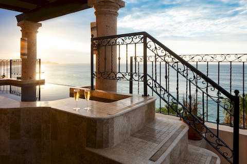 Sip a cold glass of Cava and unwind in the infinity-view hot tub on the villa's private terrace