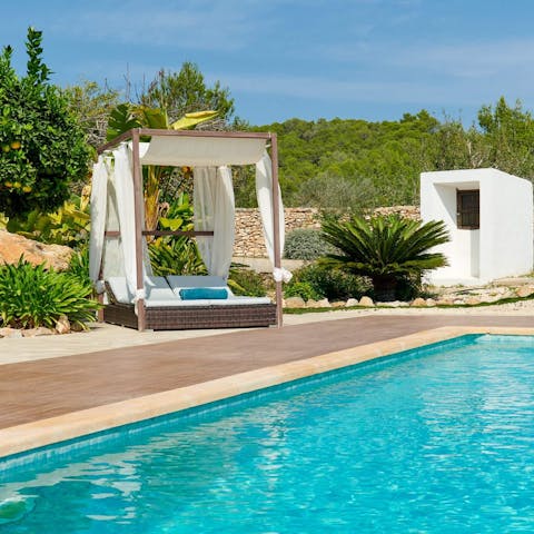 Dry off on the day bed after a refreshing dip in the pool