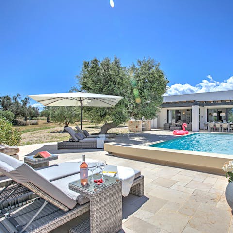 Soak up the sun by the swimming pool