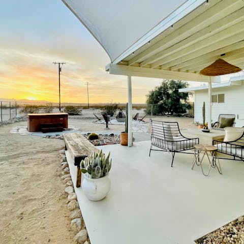 Savour a long soak in the hot tub as the sun sets over the desert