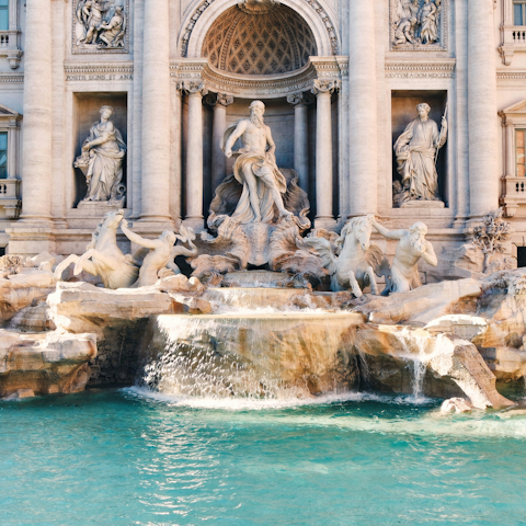 Fall in love with Rome while strolling to the Trevi Fountain