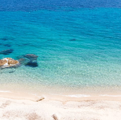 Spend the day at the beautifully pristine Psarou Beach, just a thirty-minute stroll from home