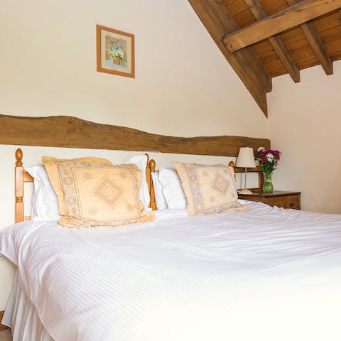 Wake up under wood beams in a historic barn, built in the 1800s