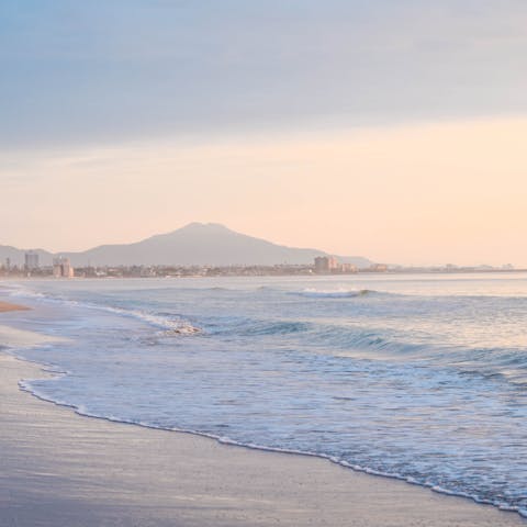 Stroll along the sands of Playa del Río Sequillo at dusk