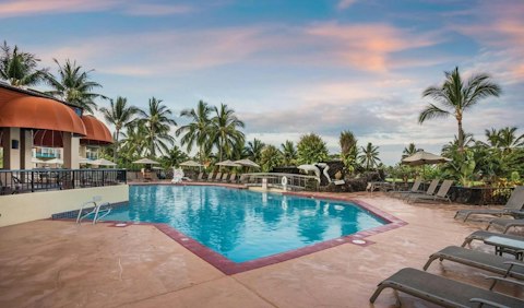 Cool off in the shared pool as the sky turns pink