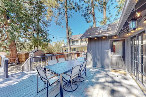 Dine alfresco under string lights among tall pines