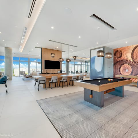 Shoot some pool in the building's game lounge