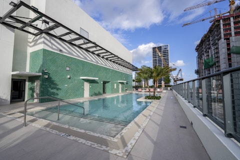 Float above the Miami skyline in the communal rooftop pool