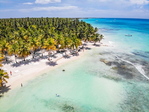 Glide across the Punta Cana lagoon waters framed by lush tropical scenery
