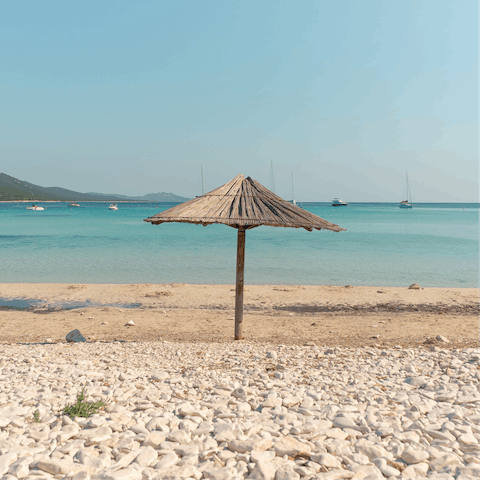 Lie back and relax on Glaros Beach, a four-minute drive away